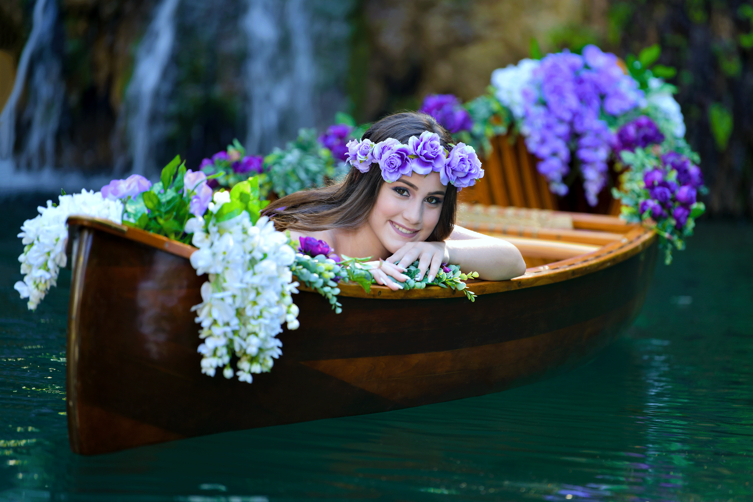 Quinceanera in a flower canoe Photo by Quinceanera Photo Studio in Miami Florida.